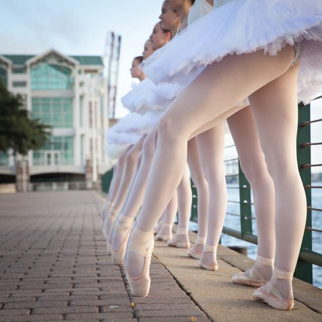 row ballerina legs leaning on the railing at Cooper Riverside Park