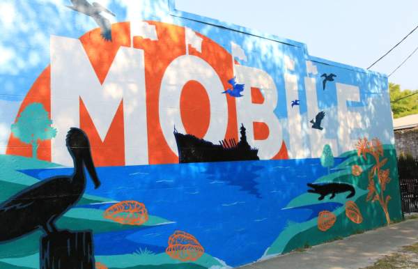 Mural with USS Alabama, pelican, alligator and water