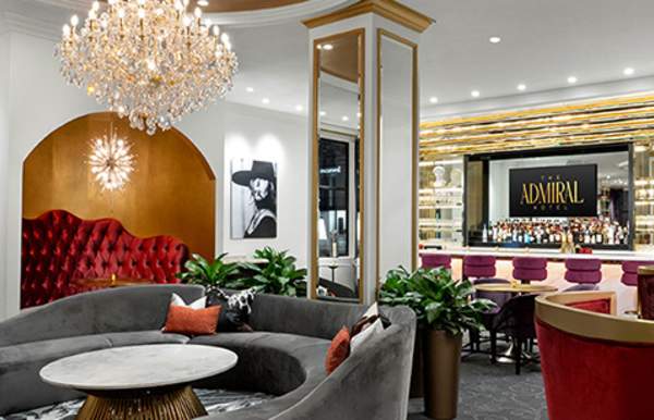 Ornate room with chandelier, seating and a bar