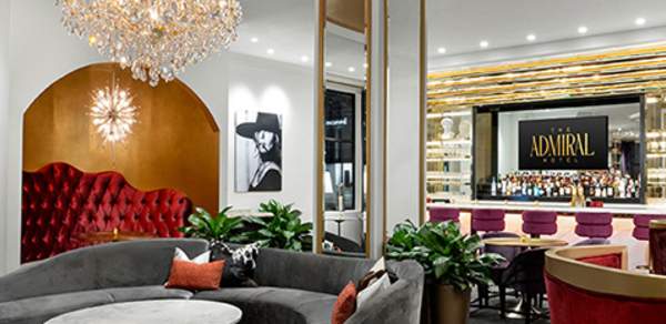 Ornate room with chandelier, seating and a bar