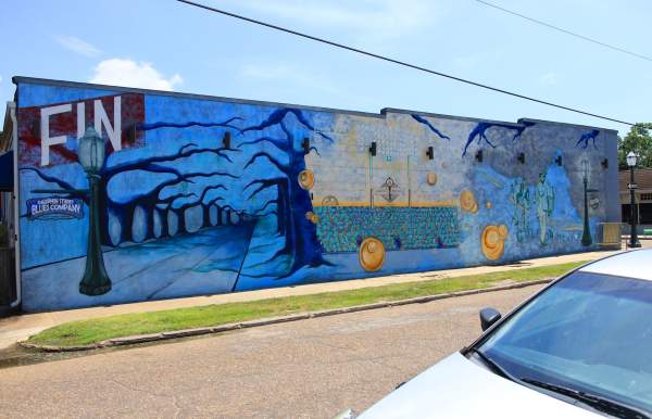 Mural of a street lined with dead trees