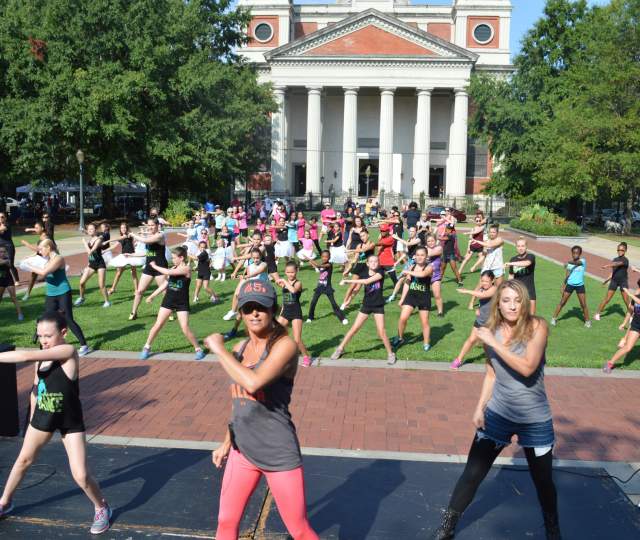 group of people doing yoga in the park