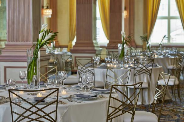 dining hall with many columns and a table with chairs