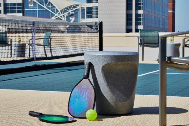 Pickleball equipment sitting on a pickleball court.