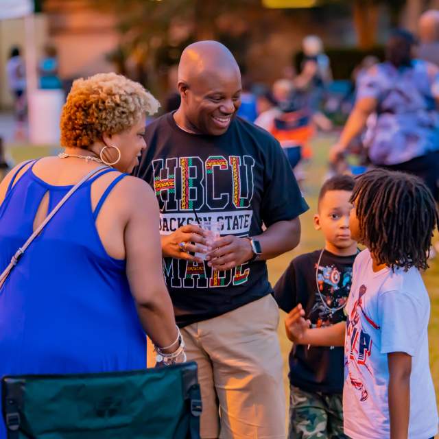 Woman, man and two small children talking