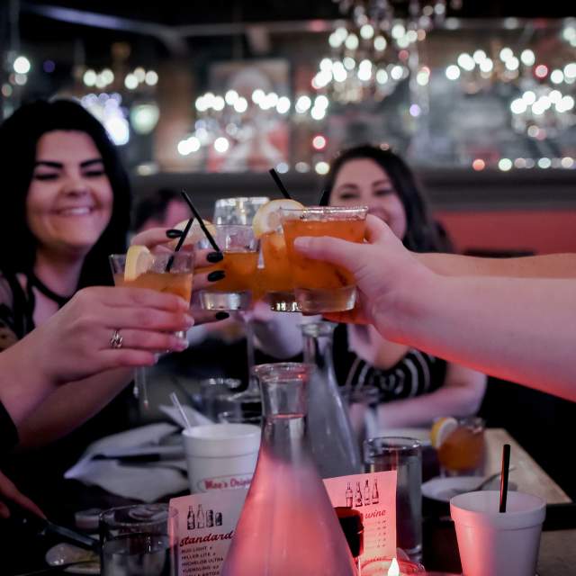 group of ladies making a toast with cocktails