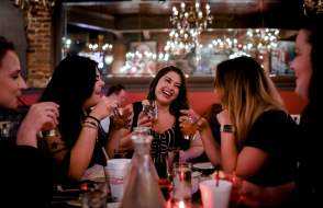 group of women drinking cocktails in a restaurant