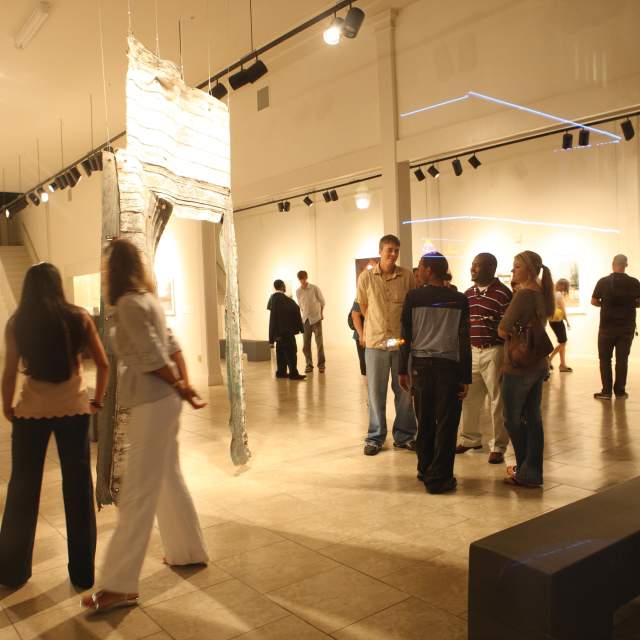 People enjoy artwork on display at a museum