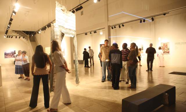 People enjoy artwork on display at a museum