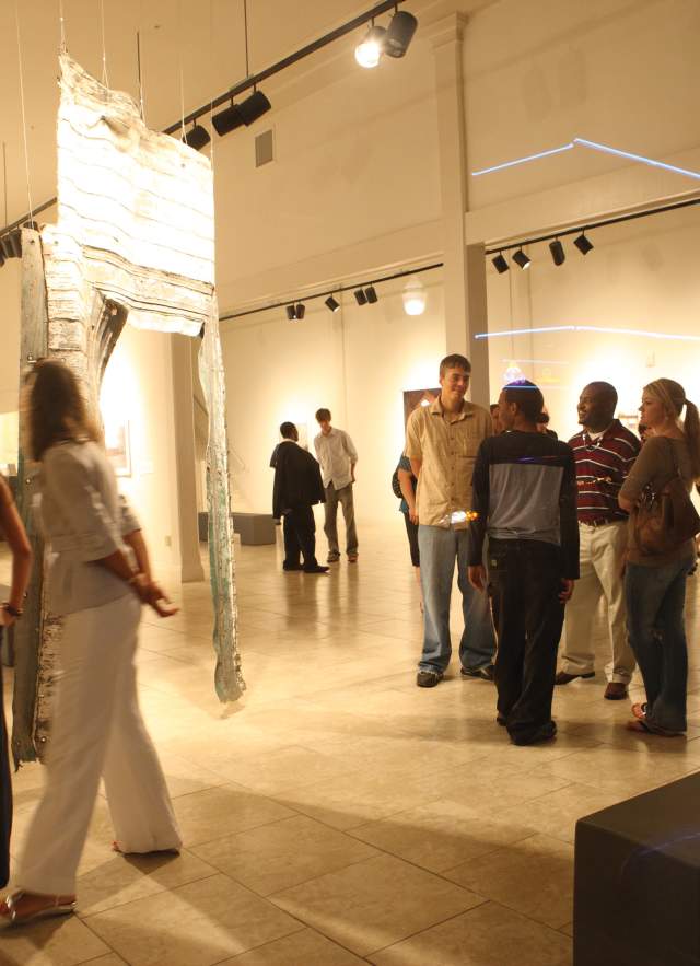 People enjoy artwork on display at a museum