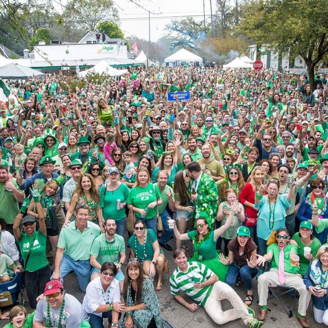 large group of people in green clothing in the street on St. Patrick's Day