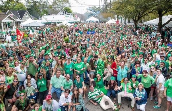large group of people in green clothing in the street on St. Patrick's Day
