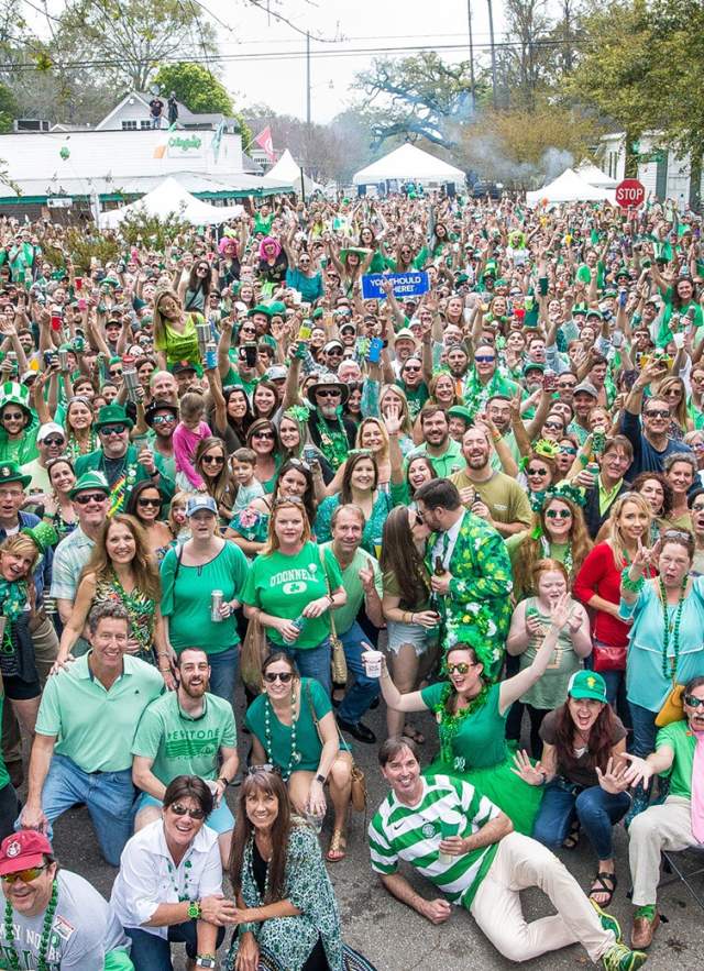 large group of people in green clothing in the street on St. Patrick's Day