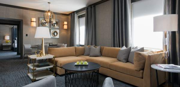 hotel suite with sectional sofa and coffee table
