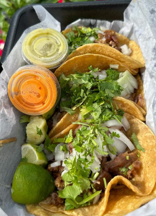 tray of tacos and sauces