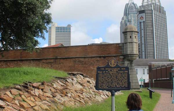 Child looking toward Fort Conde and the RSA Tower