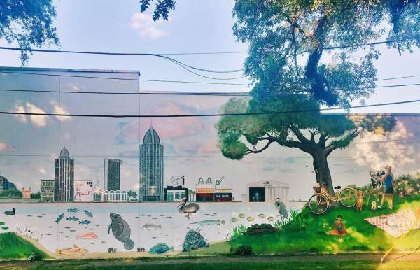 Mural of Mobile Bay in front of the city skyline