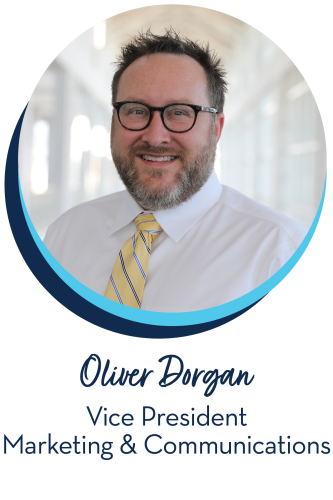 Oliver Dorgan Vice President Marketing & Communications, man with glasses, white button down shirt and yellow tie with red stripes